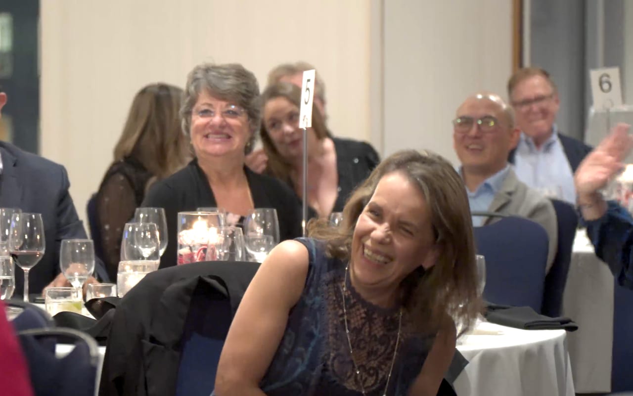 A table of guests cracking up at a Viva Funcouver event